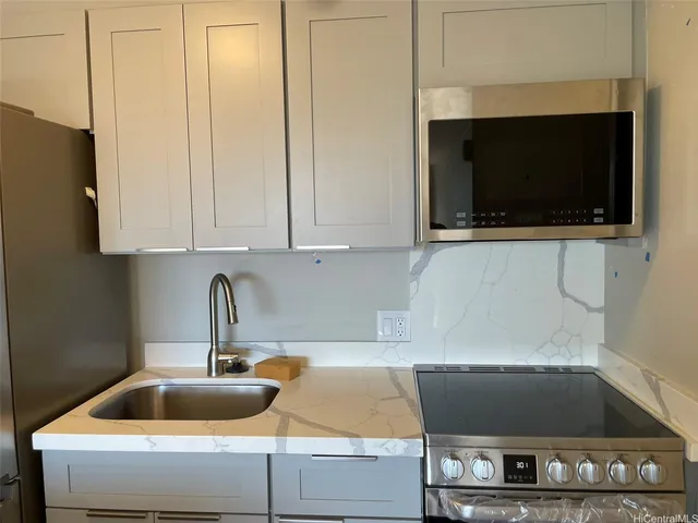 a kitchen with a sink and a microwave