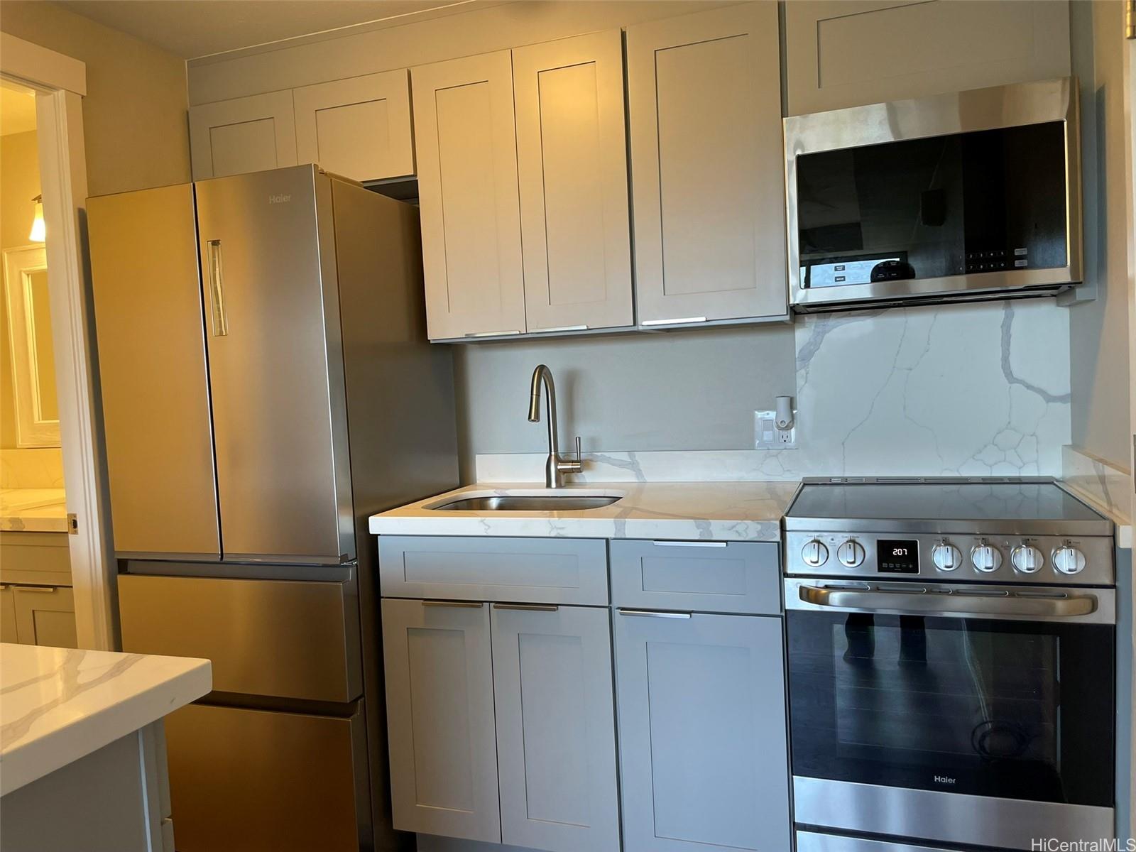 2888 Ala Ilima Street, Unit 910 Honolulu, HI 96818 - Photo 5 of 15 a kitchen with stainless steel appliances granite countertop a refrigerator a stove and a sink