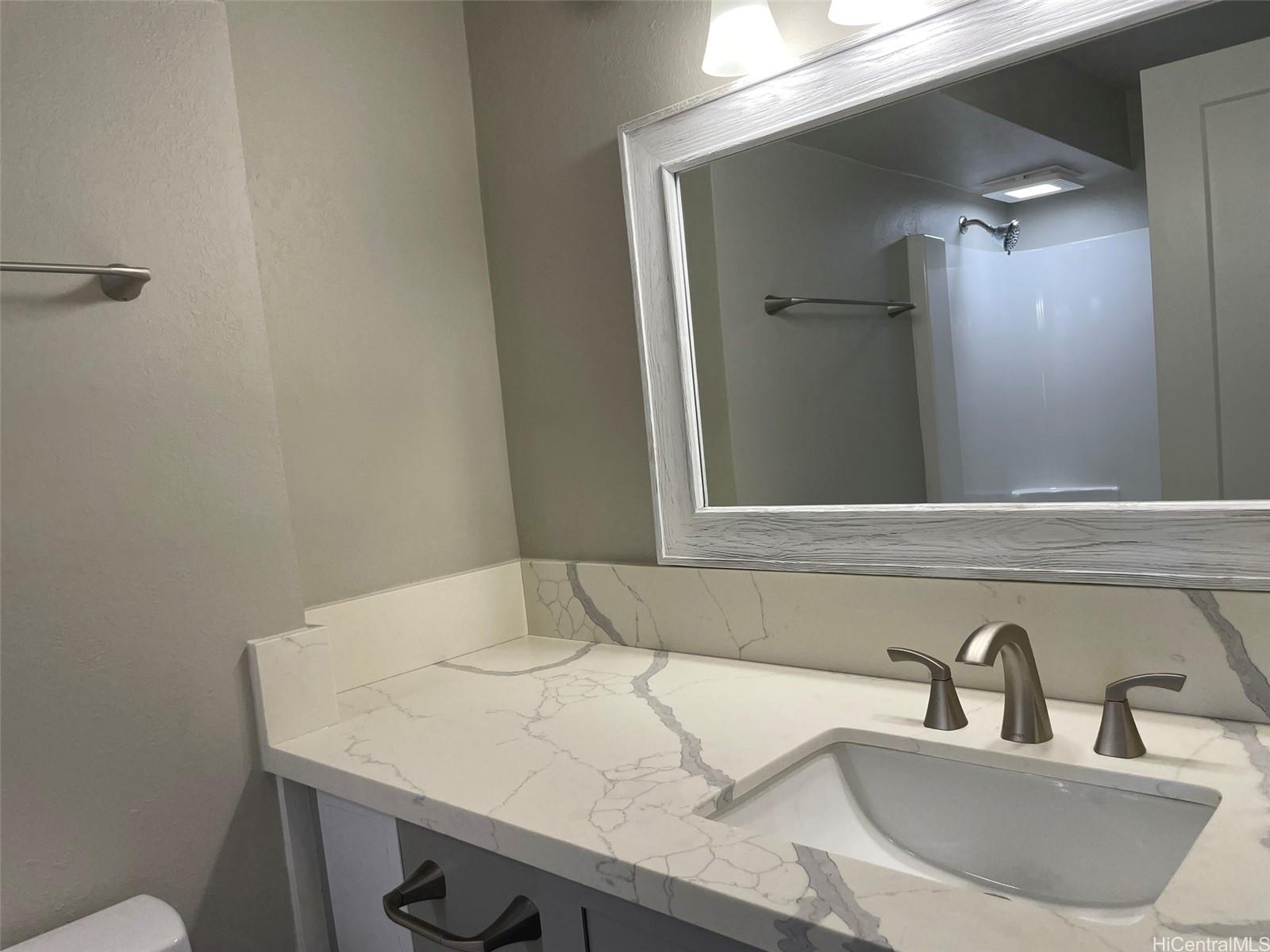 2888 Ala Ilima Street, Unit 910 Honolulu, HI 96818 - Photo 7 of 15 a bathroom with a sink and a mirror