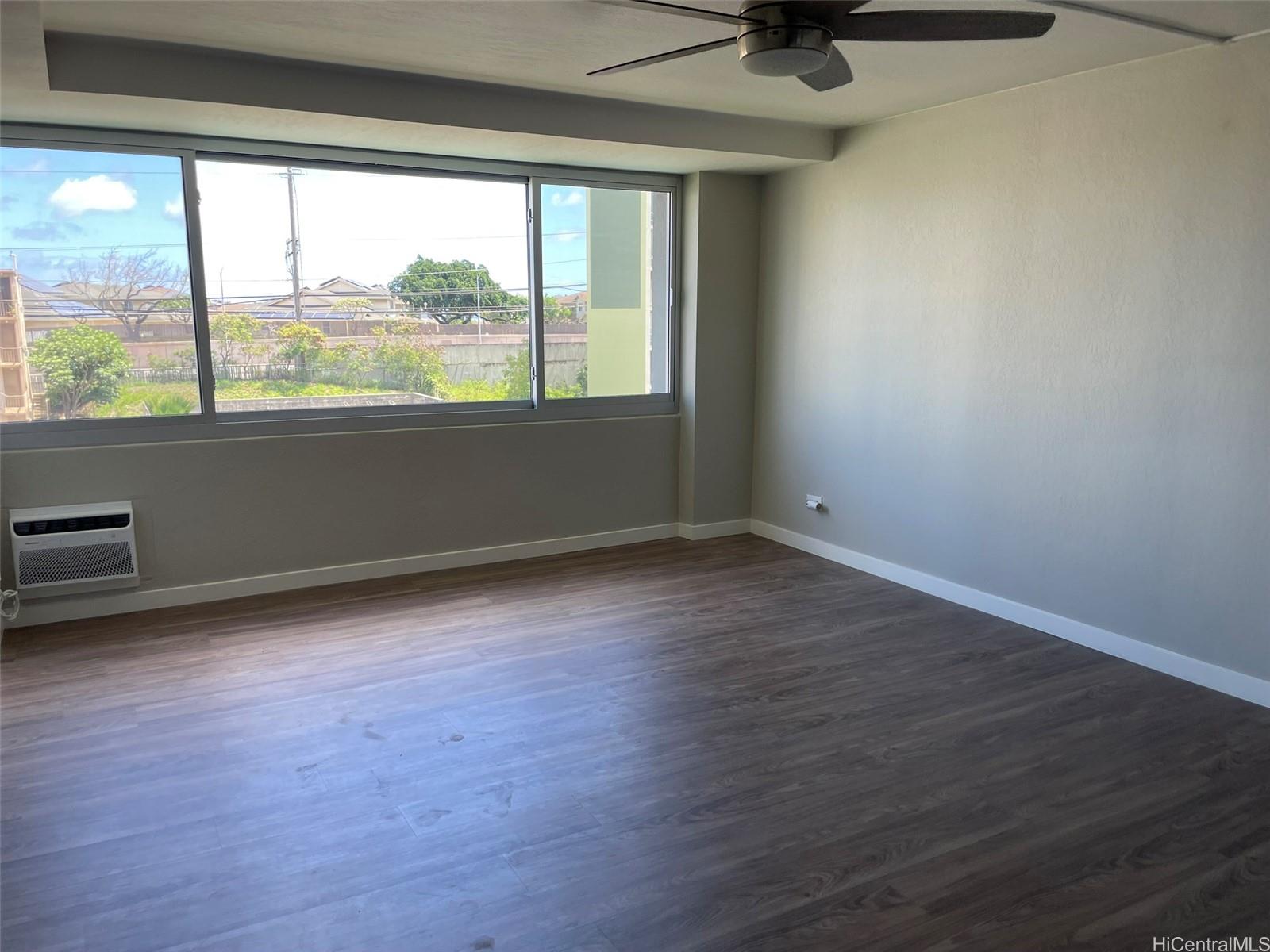 2888 Ala Ilima Street, Unit 910 Honolulu, HI 96818 - Photo 9 of 15 an empty room with wooden floor and windows