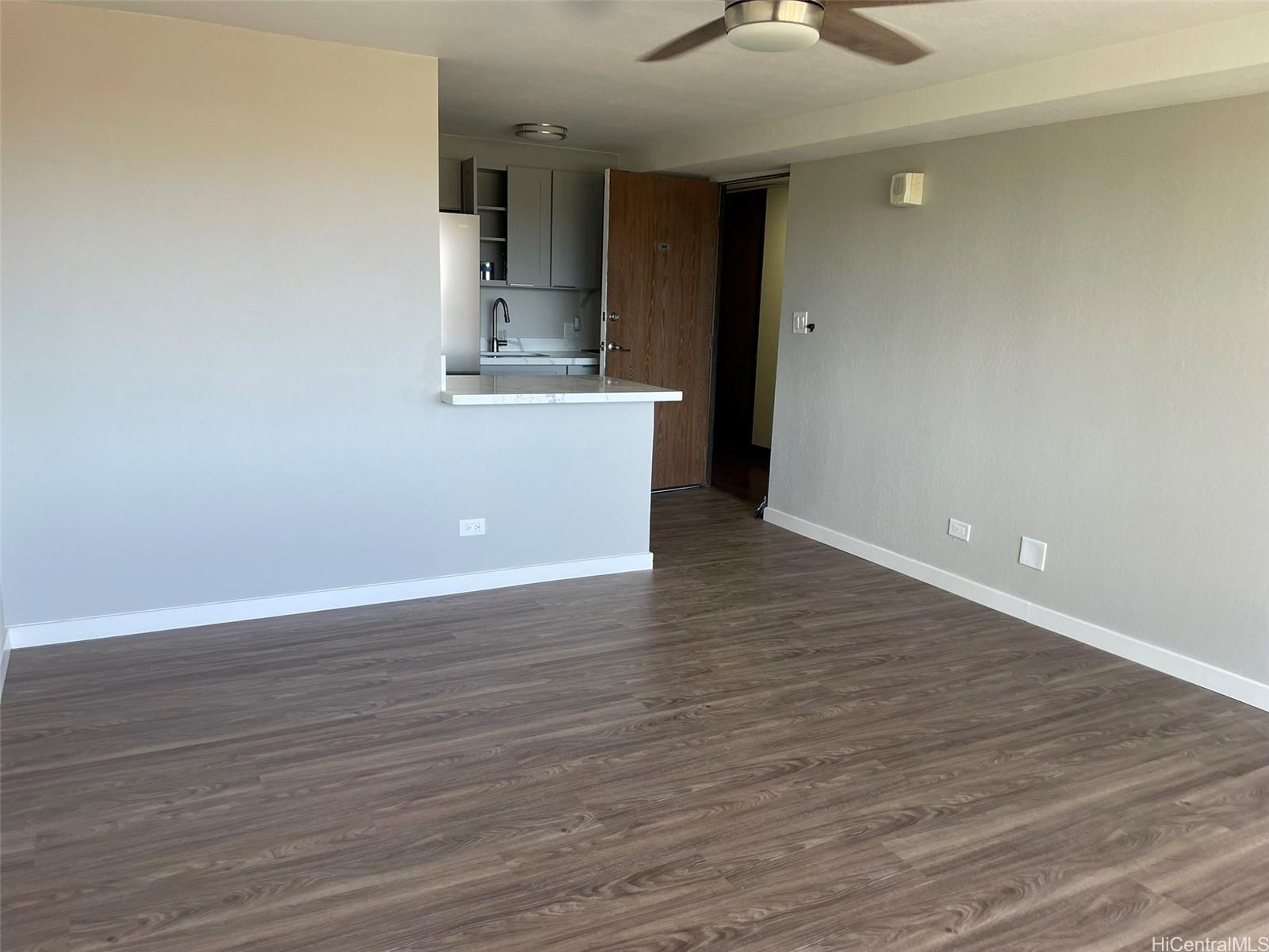 2888 Ala Ilima Street, Unit 910 Honolulu, HI 96818 - Photo 10 of 15 a view of an empty room with wooden floor and a window