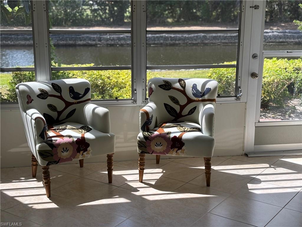 600 Valley Stream Drive, Unit D3 Naples, FL 34113 - Photo 3 of 6 a living room with furniture and a floor to ceiling window
