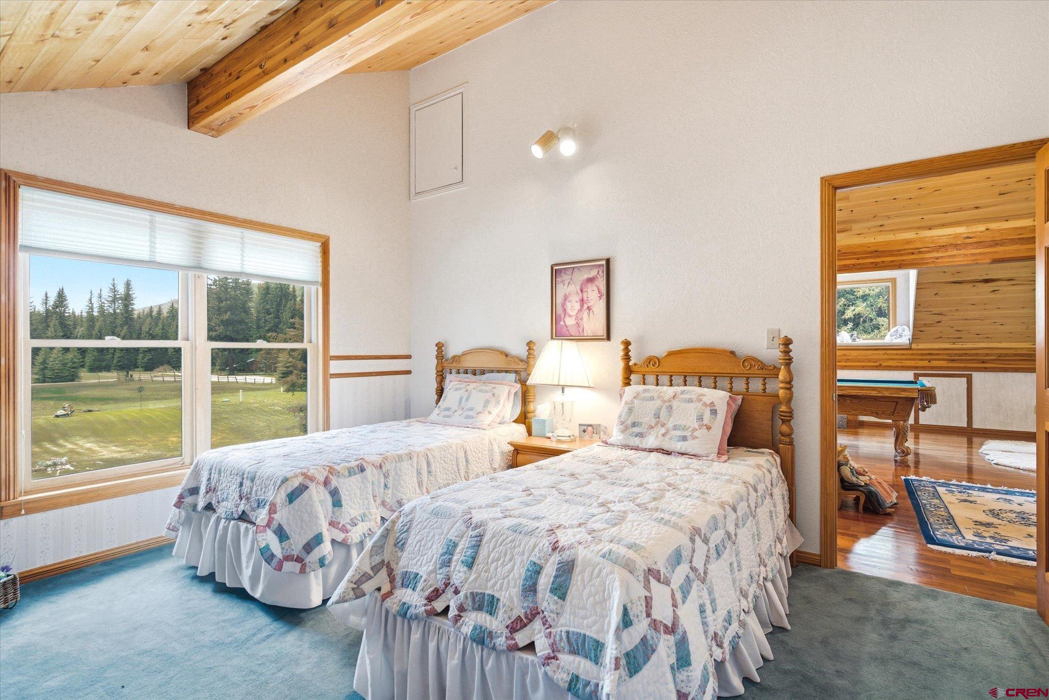 197 Hummingbird Way Bayfield, CO 81122 - Photo 24 of 44 a bedroom with two beds and large window