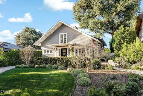 a view of a house with yard and sitting area