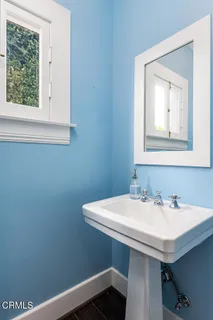 a bathroom with a sink a window and a toilet