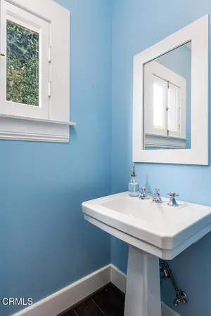a bathroom with a sink a window and a toilet