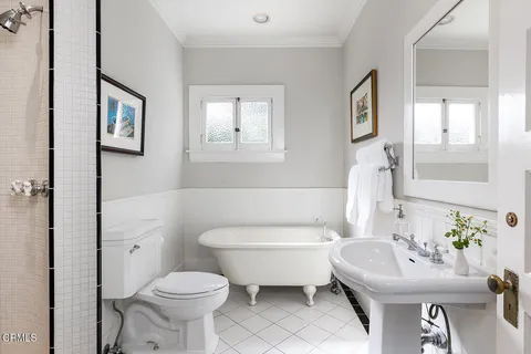 a bathroom with a sink toilet and a mirror