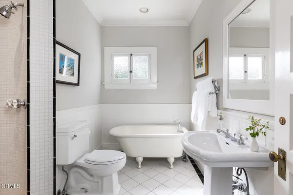 a bathroom with a sink toilet and a mirror