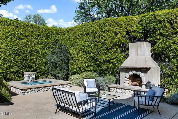 a view of a patio with a table and chairs