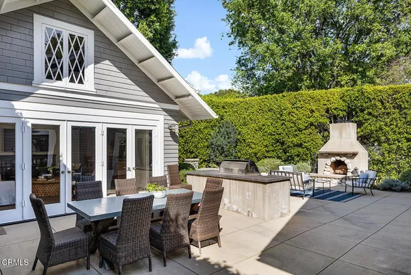 a view of a patio with table and chairs and potted plants