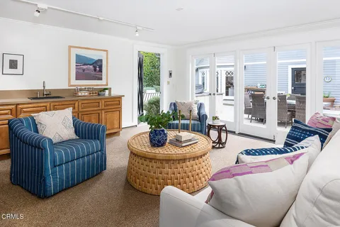 a living room with furniture a rug and a large window