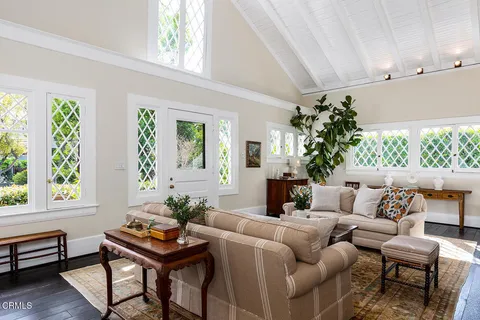 a living room with furniture and a potted plant