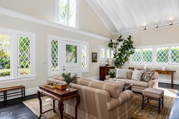 a living room with furniture and a potted plant