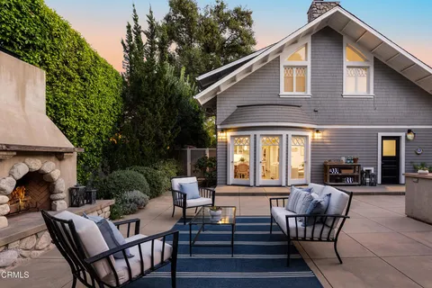 a view of a house with backyard and sitting area