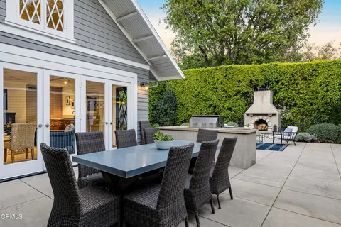 a view of a patio with a table and chairs
