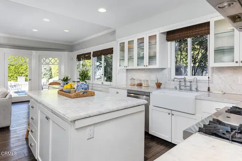 a kitchen with a sink stove and cabinets