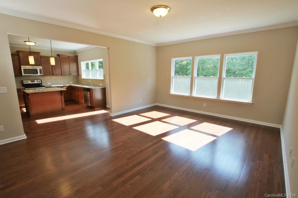 2176 Bluebell Way, Unit 172 Tega Cay, SC 29708 - Photo 8 of 22 an empty room with wooden floor and windows
