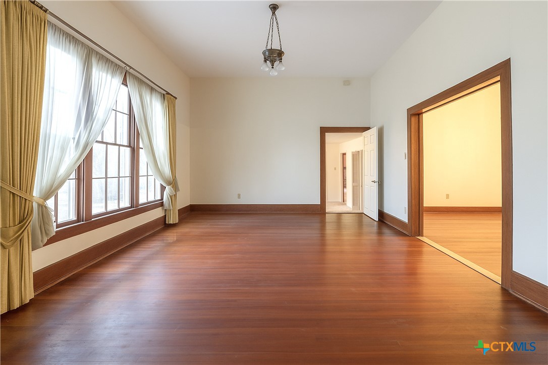 832 East Court Street Seguin, TX 78155 - Photo 11 of 31 a view of an empty room with wooden floor and a window