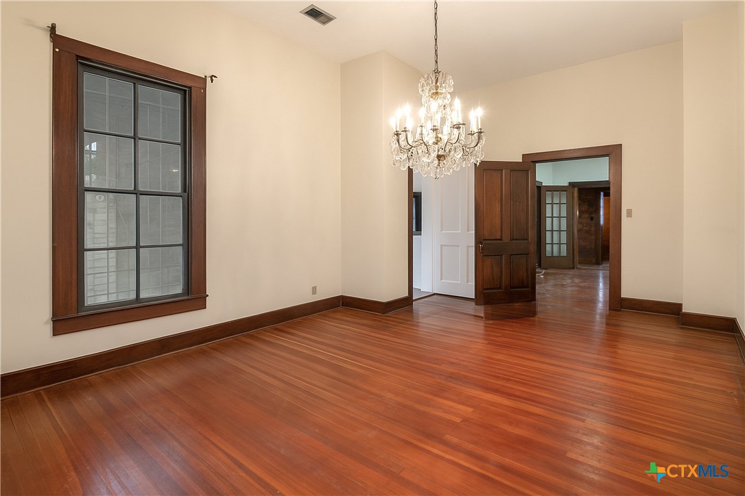 832 East Court Street Seguin, TX 78155 - Photo 13 of 31 a view of an empty room with wooden floor and a window