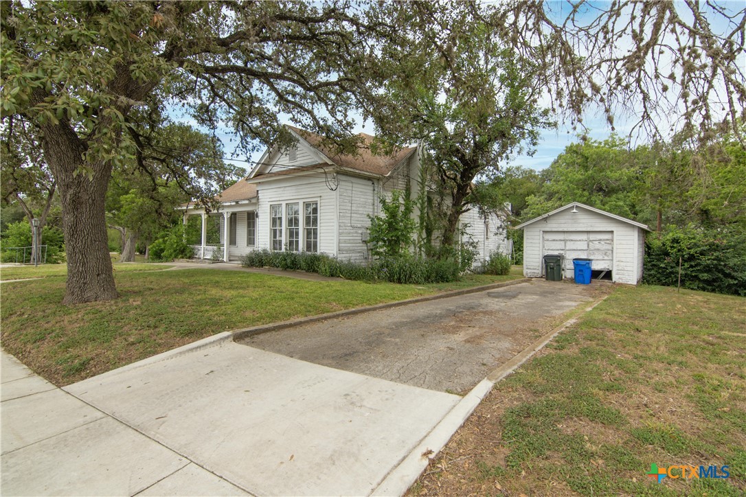 832 East Court Street Seguin, TX 78155 - Photo 30 of 31 a front view of a house with a yard and trees
