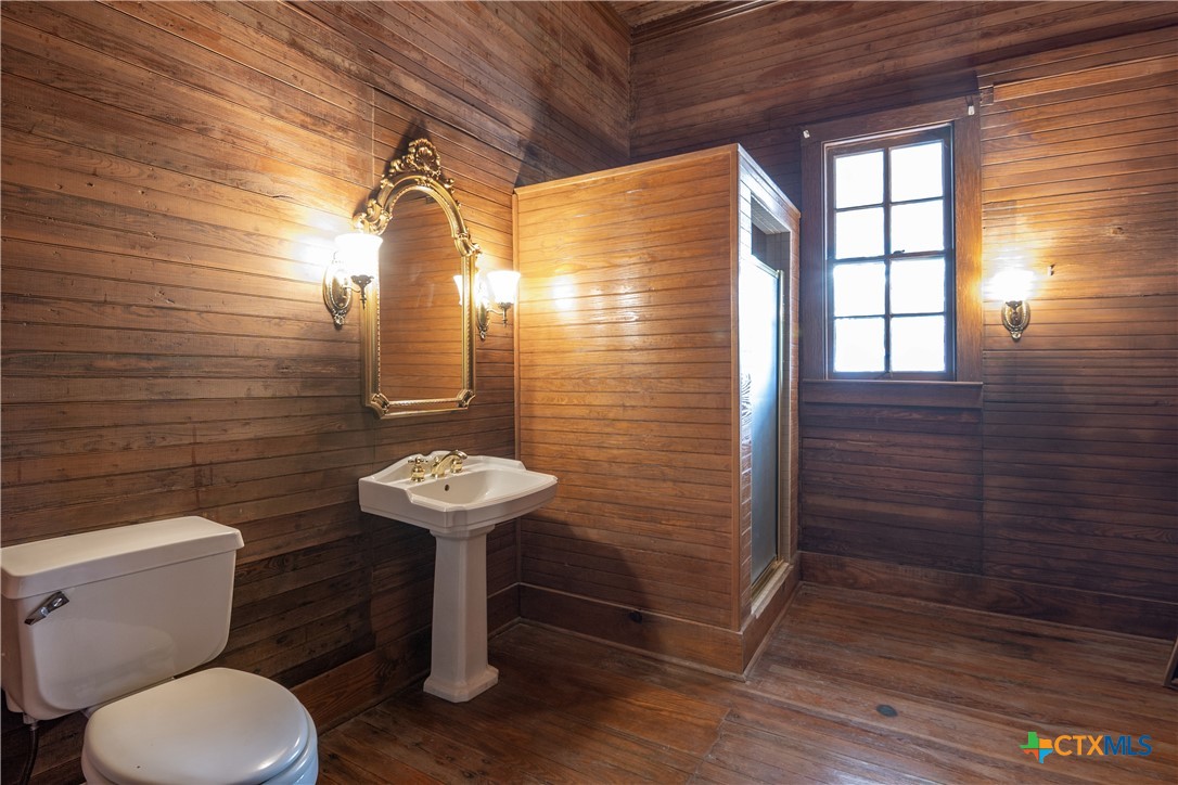 832 East Court Street Seguin, TX 78155 - Photo 6 of 31 a bathroom with a sink a toilet a mirror and shower