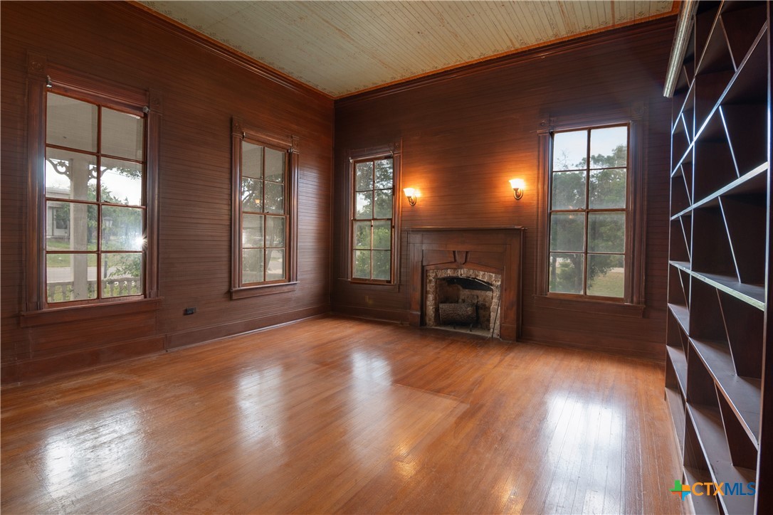 832 East Court Street Seguin, TX 78155 - Photo 7 of 31 a view of a livingroom with wooden floor and a fireplace