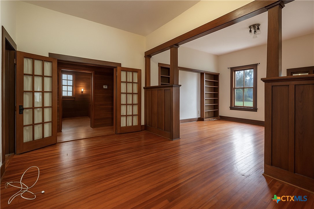 832 East Court Street Seguin, TX 78155 - Photo 9 of 31 an empty room with wooden floor and windows