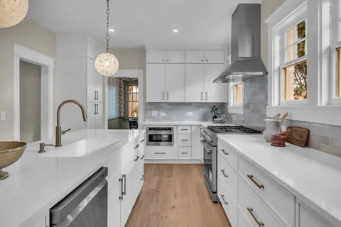 a kitchen with stove cabinets and window