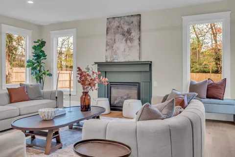 a living room with furniture and a chandelier
