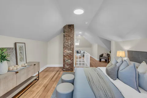 a bedroom with a large bed and a couch