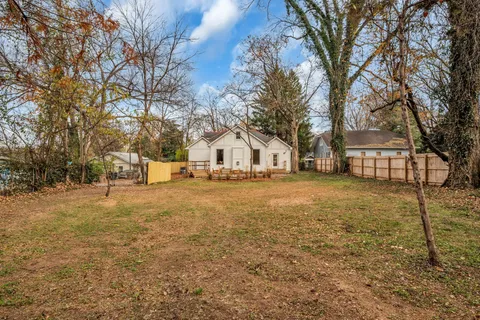 a view of a house with backyard porch and sitting area