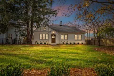 a view of a house with swimming pool and a yard