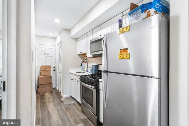a kitchen with stainless steel appliances refrigerator and cabinets