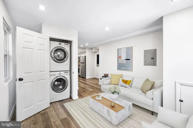 a living room with a couch and dryer