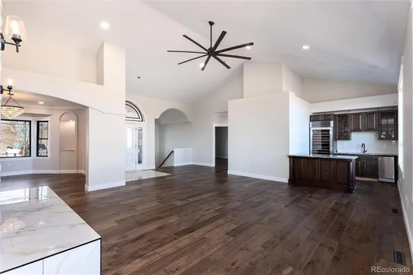 a living room with kitchen island furniture and wooden floor