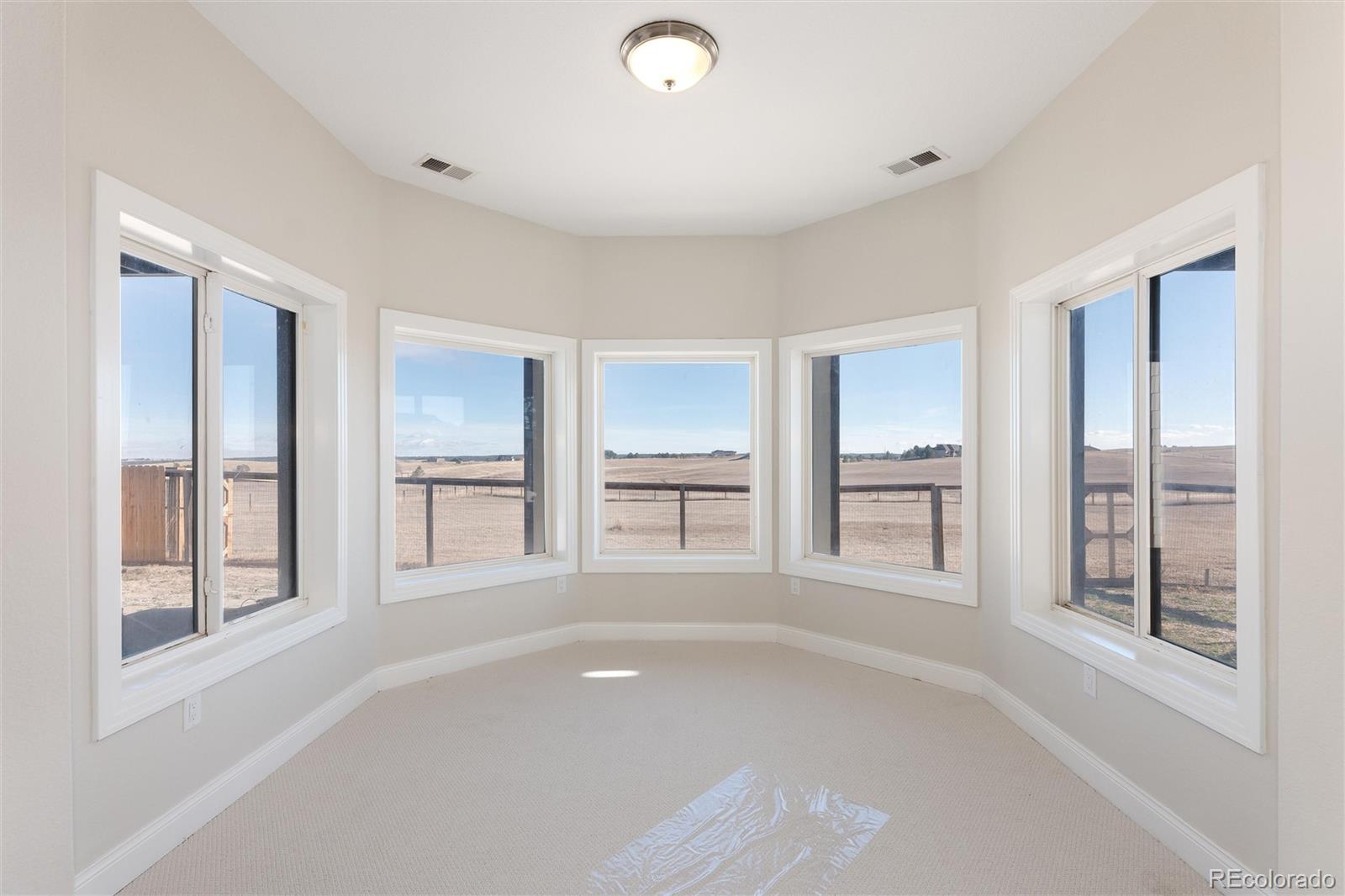 650 Coyote Trail Elizabeth, CO 80107 - Photo 45 of 50 a view of an empty room with window and cabinet area