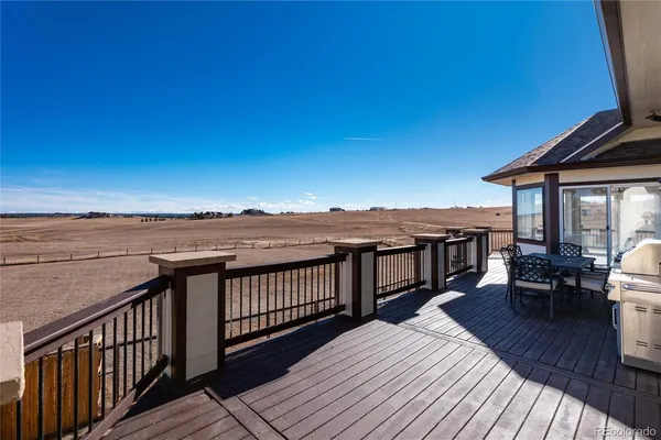 a view of a roof deck with wooden floor and city view