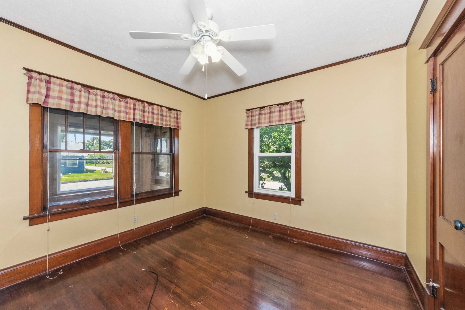 412 West 5th Street Minonk, IL 61760 - Photo 11 of 23 an empty room with wooden floor fan and windows