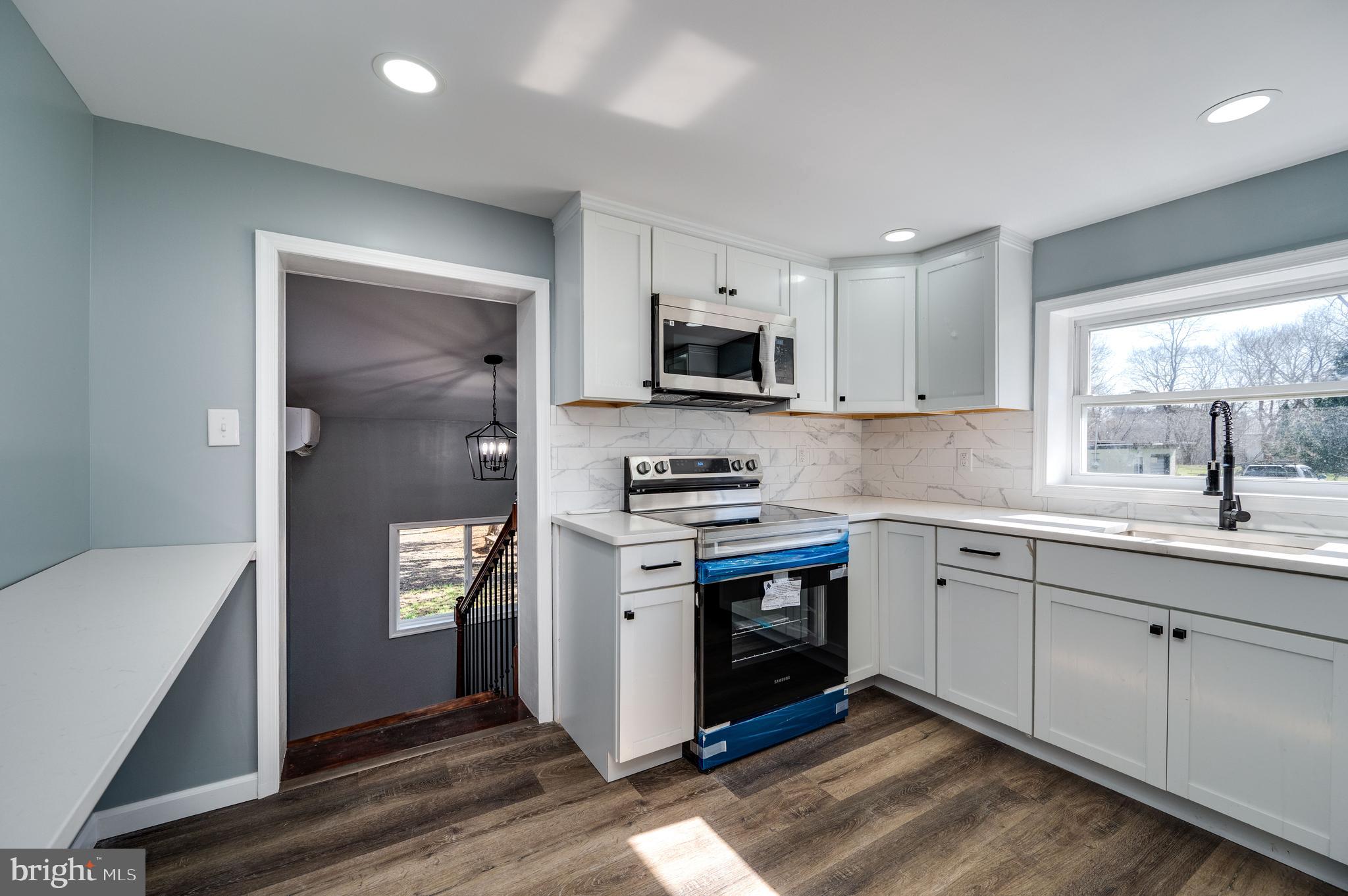 3247 State Hill Road Reading, PA 19608 - Photo 17 of 40 a kitchen with stainless steel appliances granite countertop a stove a sink and a microwave