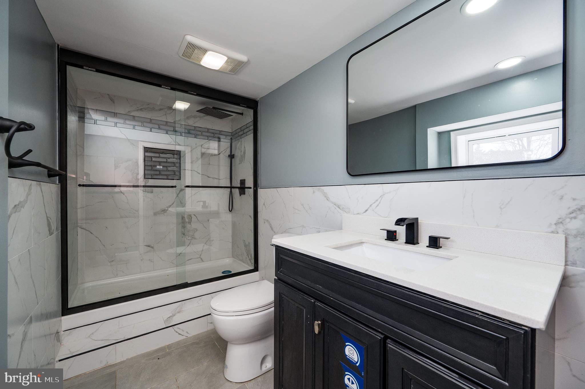 3247 State Hill Road Reading, PA 19608 - Photo 31 of 40 a bathroom with a sink a toilet a mirror and shower