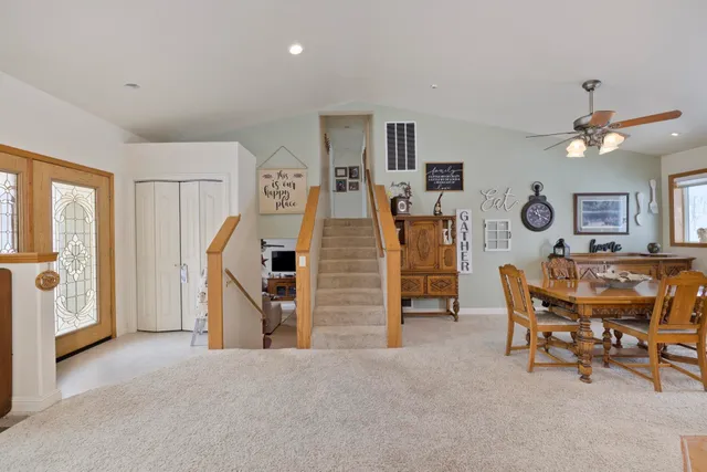 a view of a livingroom with furniture and a ceiling fan