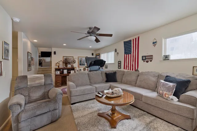 a living room with furniture and a chandelier