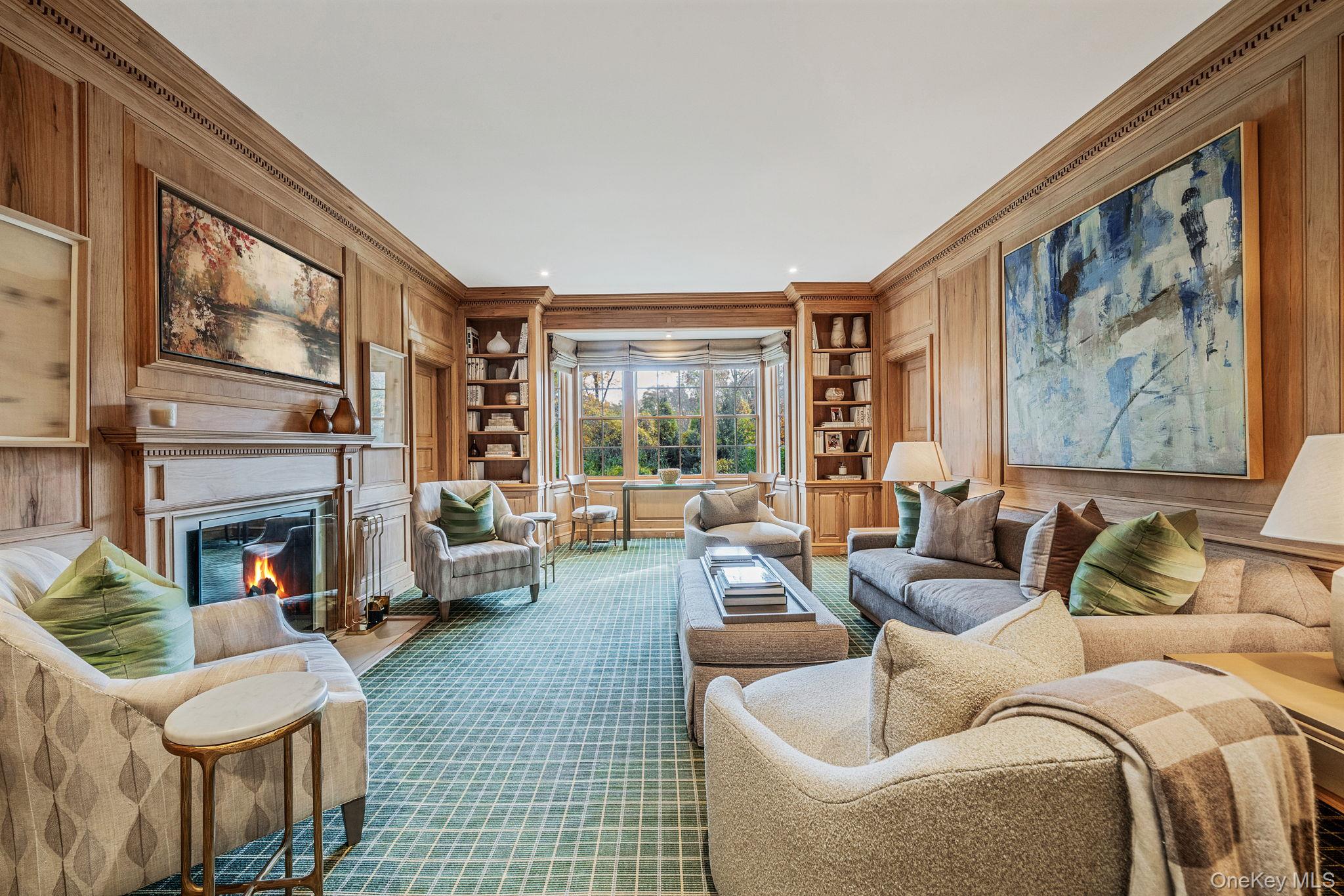 530 Chicken Valley Road Locust Valley, NY 11560 - Photo 12 of 50 Library with built in shelves, a glass covered fireplace