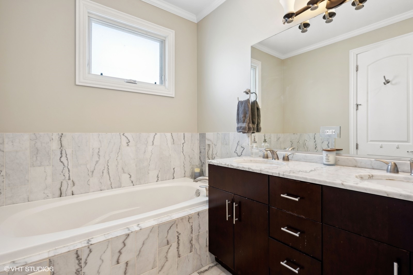 1430 West Irving Park Road, Unit 2 Chicago, IL 60613 - Photo 11 of 23 a bathroom with a tub sink and mirror