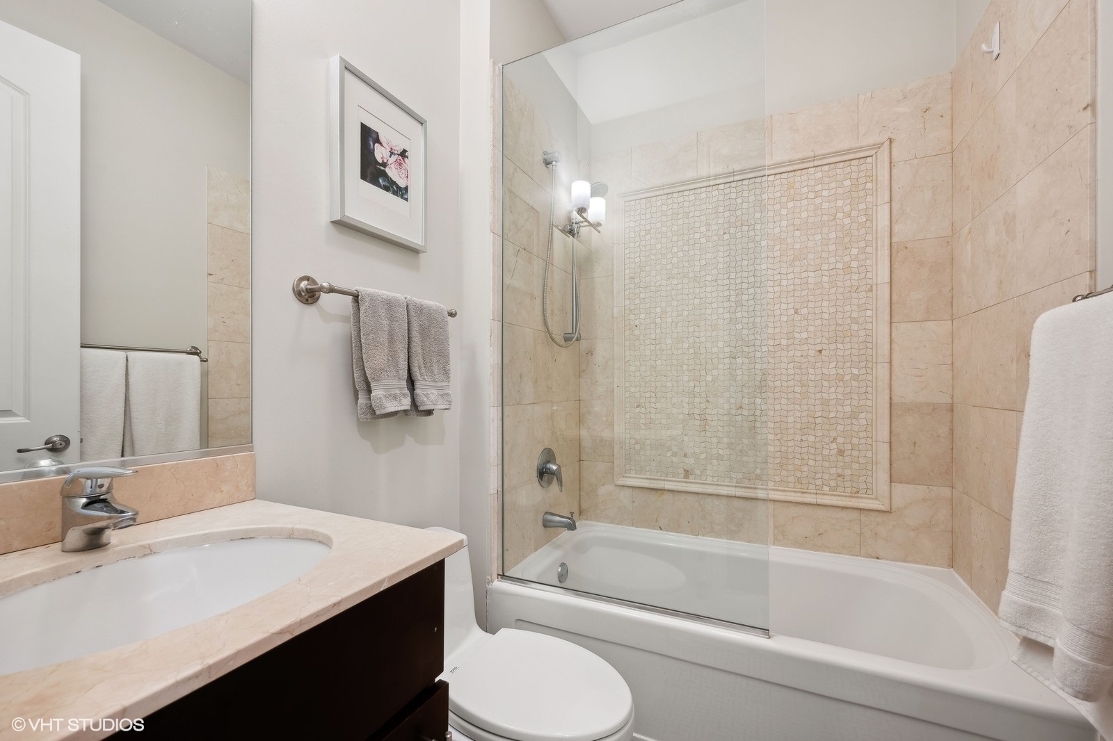 1430 West Irving Park Road, Unit 2 Chicago, IL 60613 - Photo 14 of 23 a bathroom with a bathtub sink vanity mirror and toilet