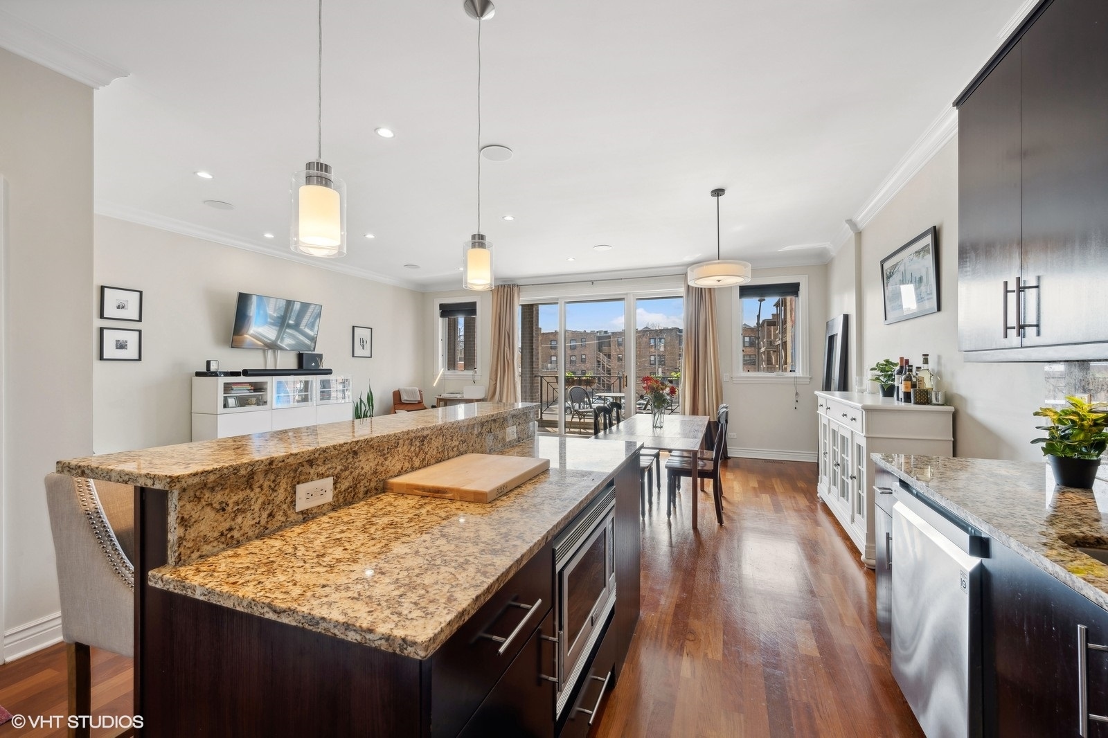 1430 West Irving Park Road, Unit 2 Chicago, IL 60613 - Photo 6 of 23 a large kitchen with kitchen island a large counter space and stainless steel appliances