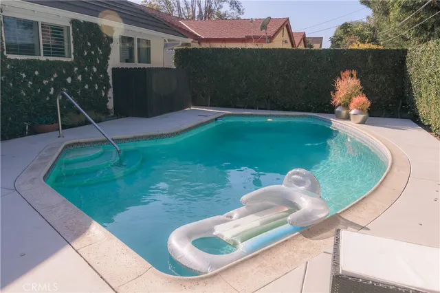 a backyard of a house with table and chairs