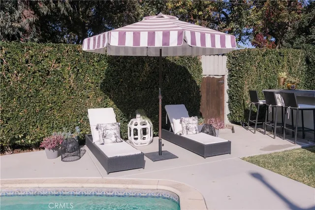 a view of a chairs and tables in the back yard of the house