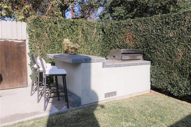 a view of a chairs and table in a backyard