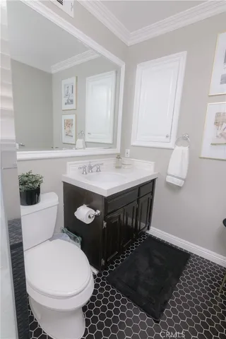 a bathroom with a sink a toilet a mirror and vanity